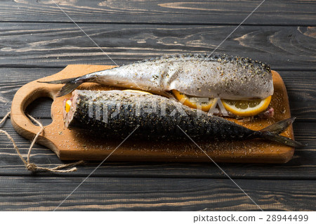 图库照片: fresh sea fish with lemon on the table