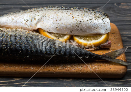 图库照片: fresh sea fish with lemon on the table