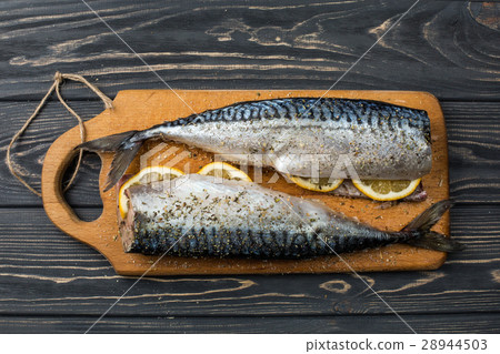图库照片: fresh sea fish with lemon on the table