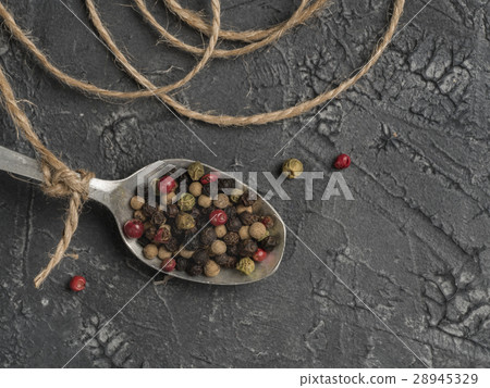 Colorful peppercorn in spoon on gray background Colorful peppercorn in spoon on gray background 28945329