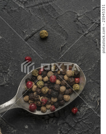Colorful peppercorn in spoon on gray background Colorful peppercorn in spoon on gray background 28945331