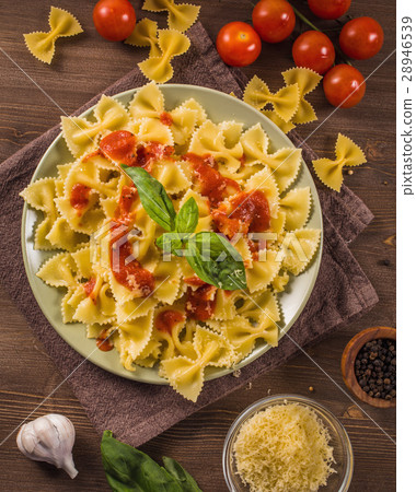 Farfalle pasta on wooden table  28946539