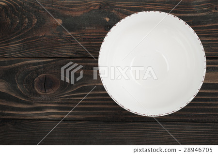 Empty plate over wooden table Empty plate over wooden table 28946705