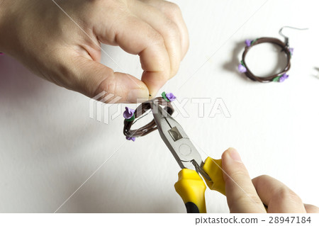 Women hands making jewelry from polymer clay Women hands making jewelry from polymer clay 28947184