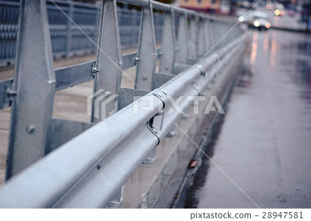 railing near the wet road 28947581
