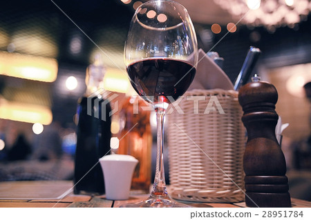 glass of red wine in restaurant interior glass of red wine in restaurant interior 28951784