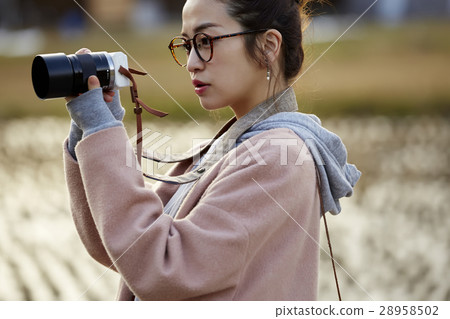A woman strolling through Shirakawago Goseisaki settlement 28958502