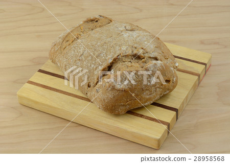 Loaf of sweet potato bread on wooden cutting board 28958568
