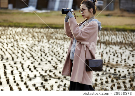 A woman strolling through Shirakawago Goseisaki settlement 28958578