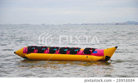 colorful banana boat floating on the sea colorful banana boat floating on the sea 28958884