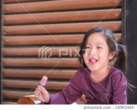 Little Asian girl eating ice cream Little Asian girl eating ice cream 28963484