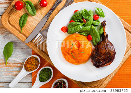 roasted duck leg with mashed pumpkin and salad 28963765