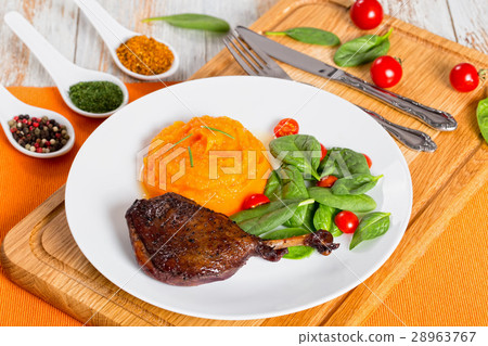 roasted duck leg with mashed pumpkin and salad 28963767