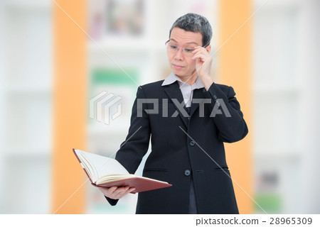 woman reading book having problem with her eyes 28965309