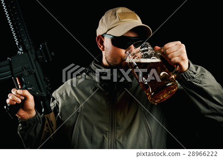 man with a gun drinking beer man with a gun drinking beer 28966222