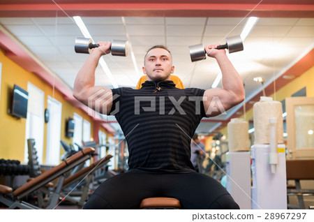 Athletic man is holding the barbell over the head Athletic man is holding the barbell over the head 28967297