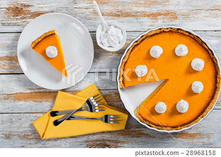 portion of bright orange pumpkin open pie 28968158