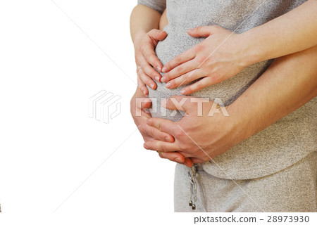 Happy young couple showing heart on belly of pregn Happy young couple showing heart on belly of pregn 28973930