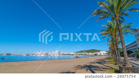 Man heads toward abandoned sailboat on the beach. 28975754