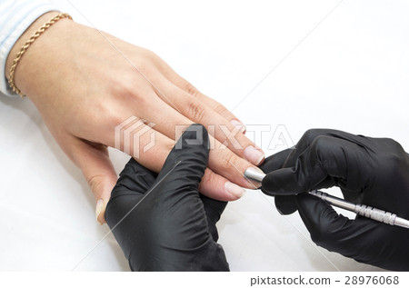 Woman hands doing manicure beauty salon close-up Woman hands doing manicure beauty salon close-up 28976068