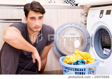 Young husband man doing laundry at home Young husband man doing laundry at home 28978988