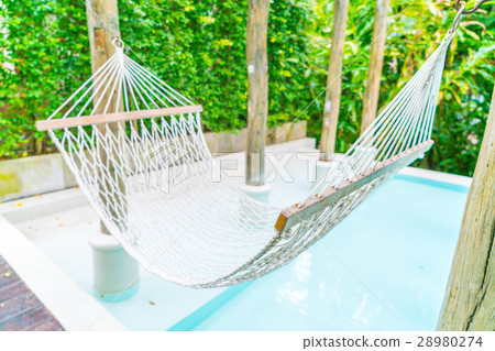 White hammocks in Luxury swimming pool . 28980274