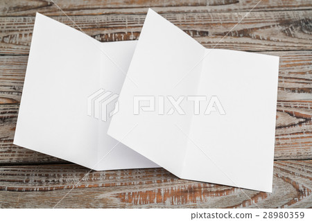 Bifold white template paper on wood texture . 28980359