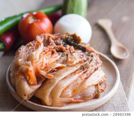 Kimchi on wood dish and wood floor 28983396