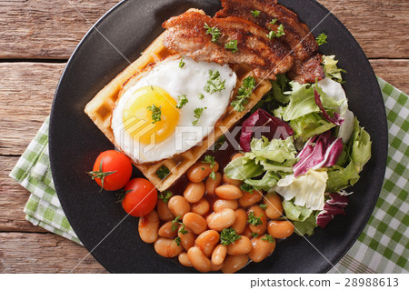 hearty breakfast with fried egg, waffles, bacon 28988613