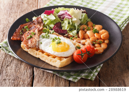 hearty breakfast with fried egg, waffles, bacon 28988619