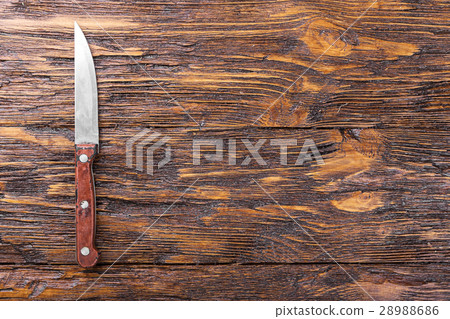 Knife on a wooden board 28988686