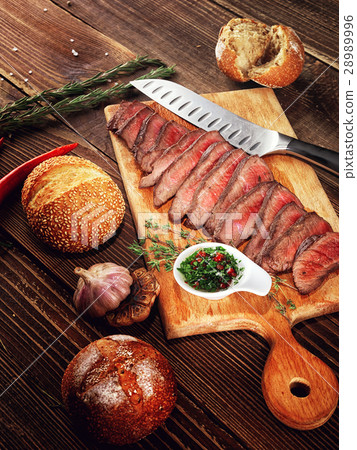 Roast beef steak on a wooden stand. 28989996