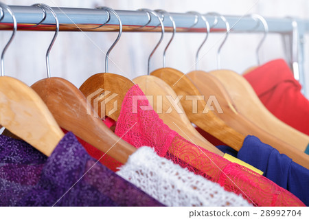 colorful womens clothes on hangers on rack in 28992704
