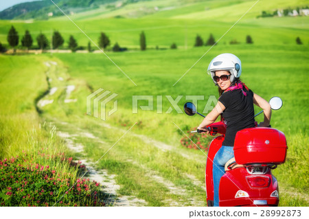 Young woman traveling by a scooter 28992873