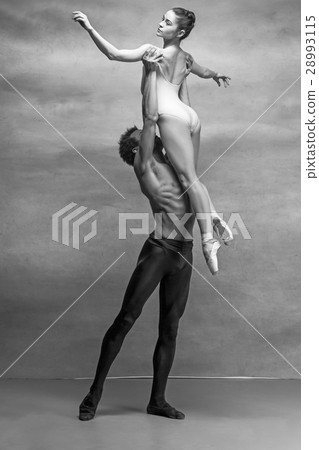 Couple of ballet dancers posing over gray 28993115