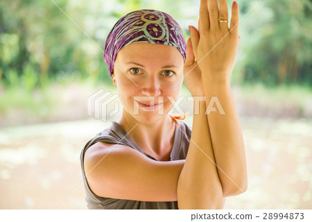 Young woman practicing garudasana 28994873