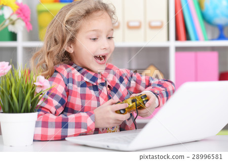 Girl is playing a computer game Girl is playing a computer game 28996581