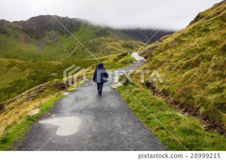 Person walking on a path in Snowdonia National Par 28999215