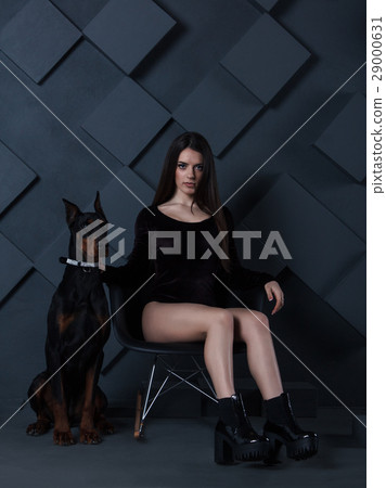 brunette in bodysuit sitting with doberman dog brunette in bodysuit sitting with doberman dog 29000631