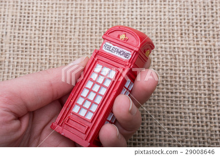 Hand holding a phone booth on a canvas background Hand holding a phone booth on a canvas background 29008646