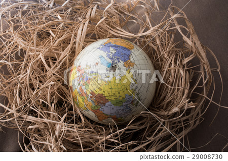 Little model globe put on a straw background 29008730