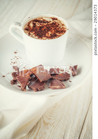 Mug of cocoa and chocolate on a plate 29014373