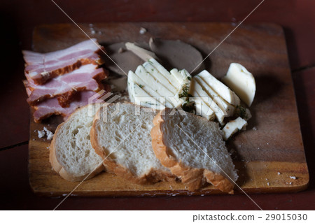bread meat and cheese on old cutting Board bread meat and cheese on old cutting Board 29015030