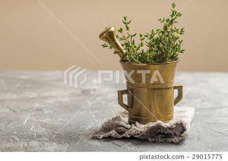 Fresh green thyme in old metal mortar 29015775