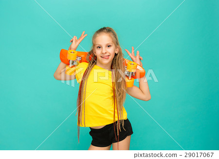 Pretty skater girl holding skateboard 29017067