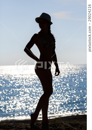 Silhouette of woman on sea coast Silhouette of woman on sea coast 29024216
