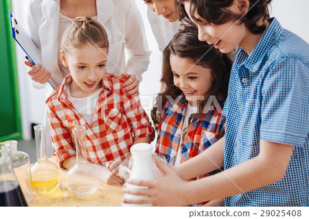 Happy enthusiastic boy toughing a flask 29025408