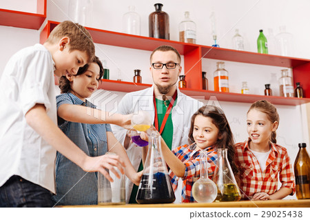 Nice experienced teacher looking at the children 29025438