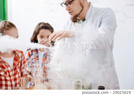 Serious experienced scientist performing a Serious experienced scientist performing a 29025629