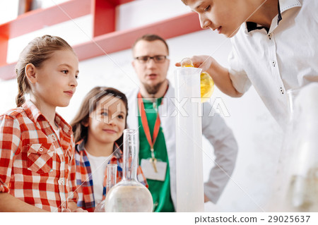 Nice delighted children carrying out a chemical Nice delighted children carrying out a chemical 29025637